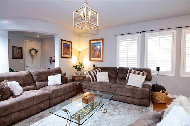 living room with hardwood / wood-style floors and an inviting chandelier