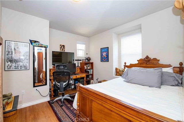 bedroom with hardwood / wood-style flooring