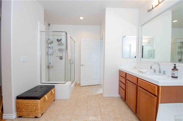 bathroom featuring a shower with door, tile patterned floors, and vanity