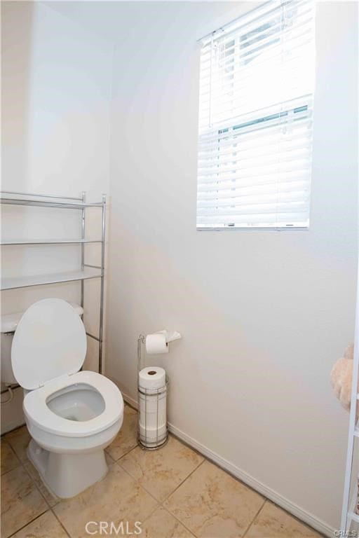 bathroom with tile patterned flooring and toilet