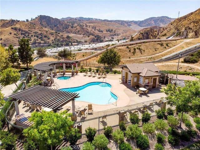 view of pool with a patio and a mountain view