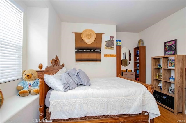 bedroom with hardwood / wood-style flooring