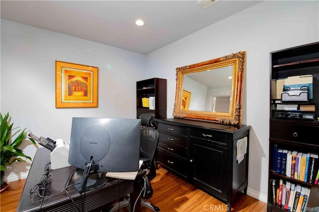 home office with hardwood / wood-style floors