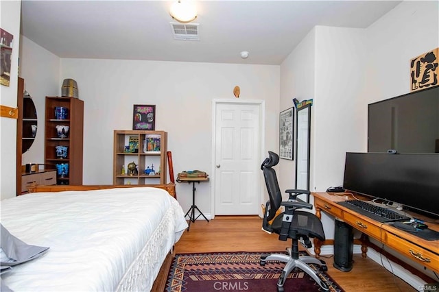 bedroom with hardwood / wood-style flooring