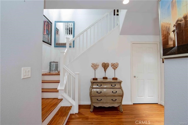 staircase with wood-type flooring