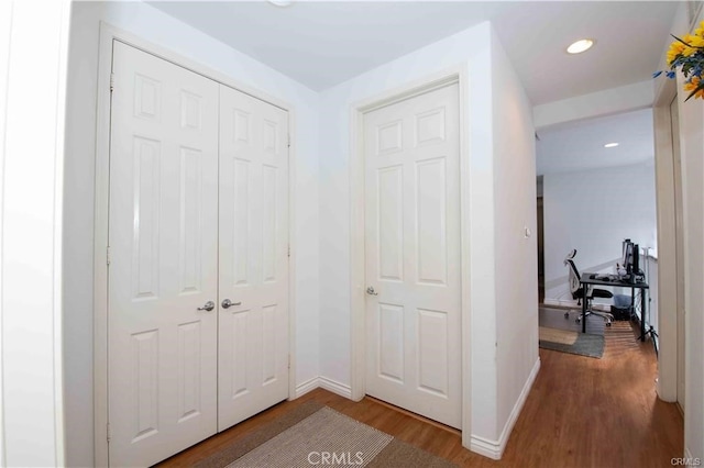 hallway with hardwood / wood-style floors