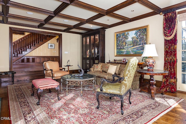 living room featuring beamed ceiling, coffered ceiling, and crown molding