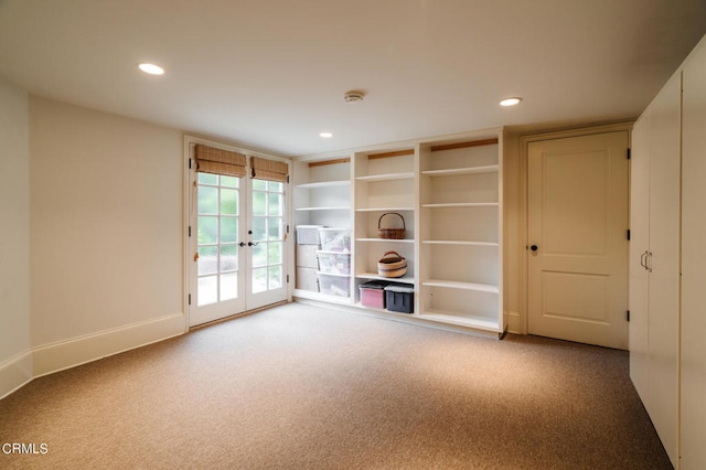 empty room with french doors and carpet floors