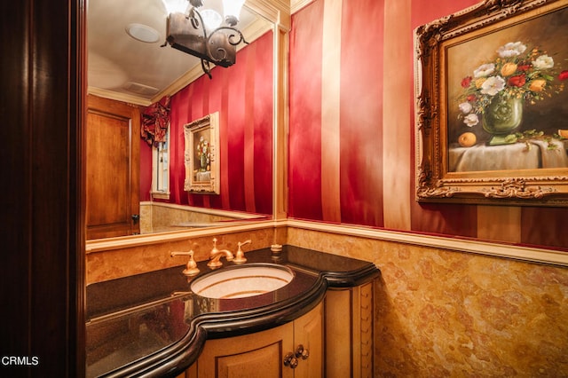 bathroom featuring ornamental molding, an inviting chandelier, and vanity