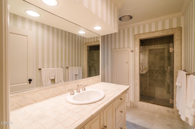 bathroom with tile patterned flooring, a shower with door, and vanity