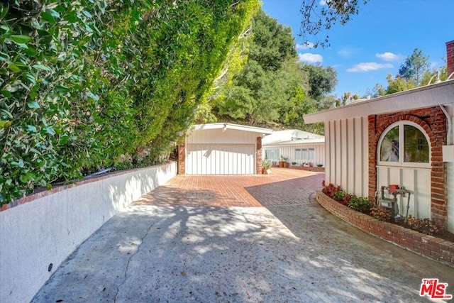 exterior space with a garage and an outbuilding