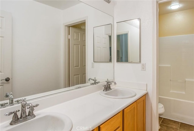 full bathroom featuring tile patterned flooring, vanity,  shower combination, and toilet