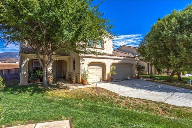 view of front of home with a front yard and a garage