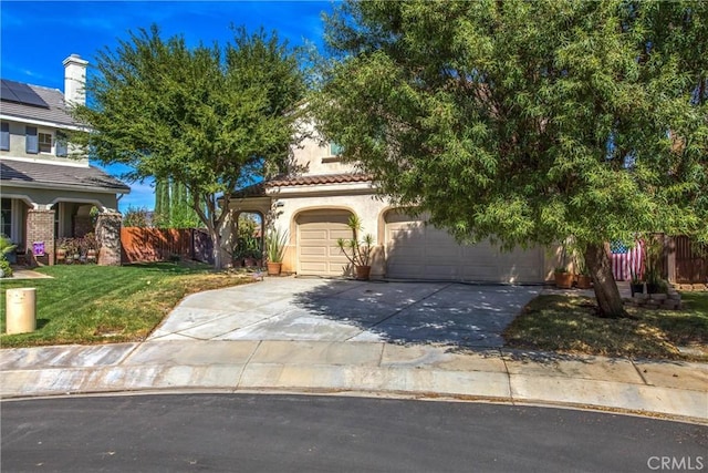 view of property hidden behind natural elements featuring a garage and a front lawn