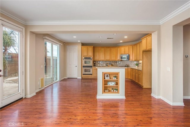 kitchen with dark wood finished floors, appliances with stainless steel finishes, light countertops, and ornamental molding