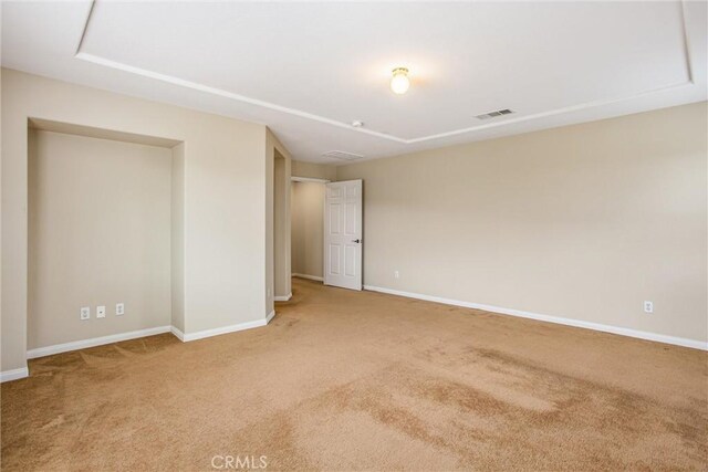 spare room with baseboards, visible vents, and carpet floors