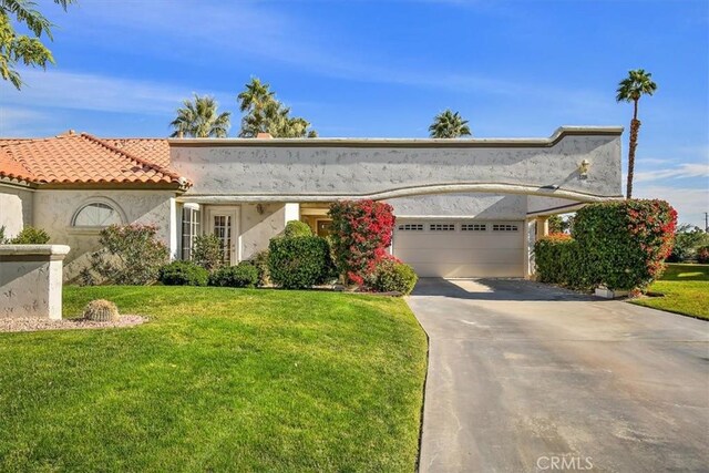 view of front of home with a garage and a front yard