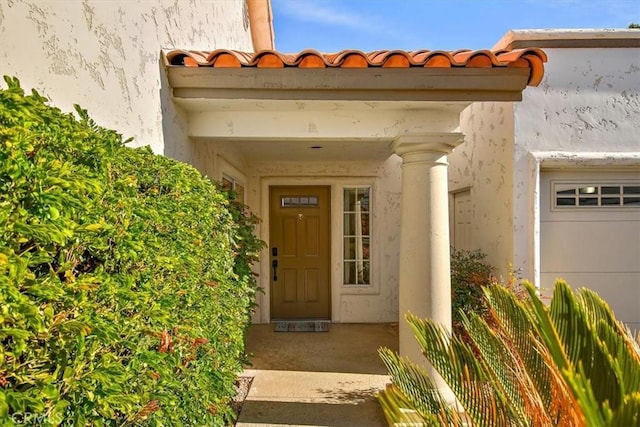 doorway to property with a garage