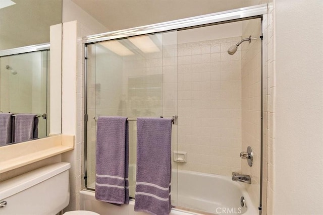 bathroom featuring toilet and enclosed tub / shower combo