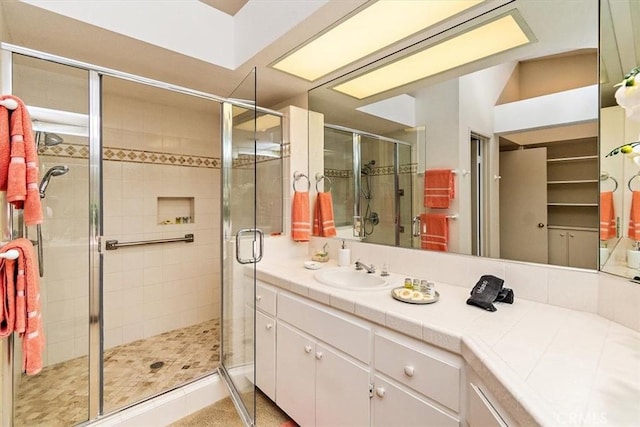 bathroom featuring vanity and an enclosed shower