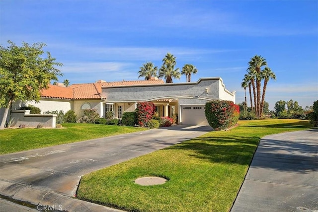 view of front of property with a front yard and a garage