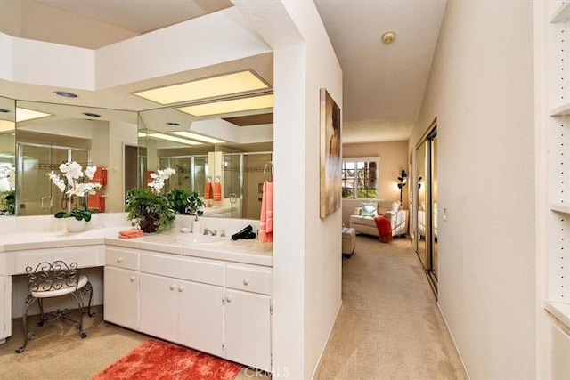 bathroom with vanity and a shower with shower door