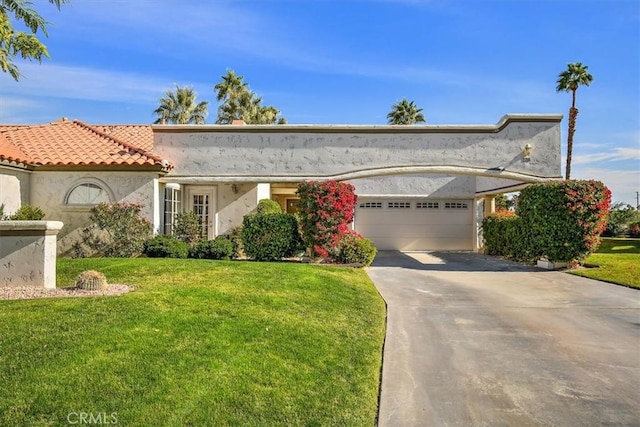 128 Desert Falls Dr E, Palm Desert, CA 92211 - view of front facade featuring a front lawn, stucco siding, an attached garage, and driveway