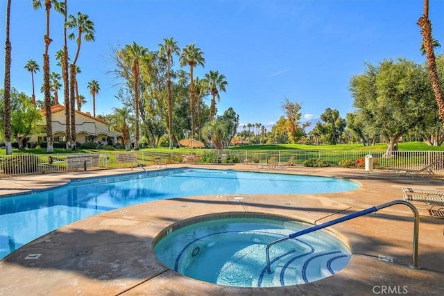 view of pool with an in ground hot tub