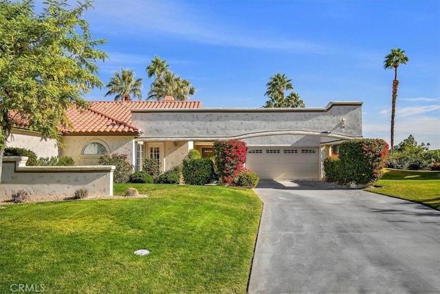 view of front of home with a garage and a front yard