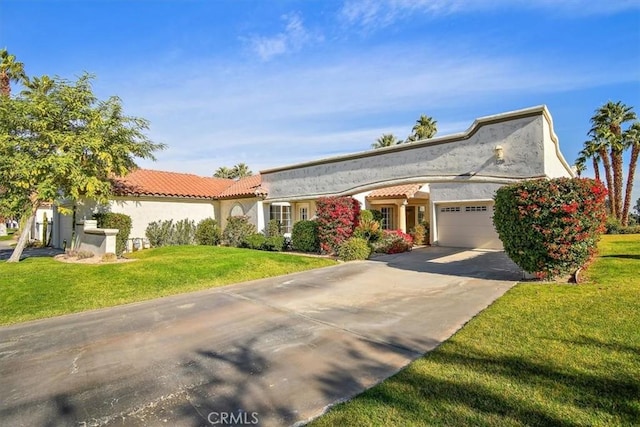 view of front of property featuring a garage and a front yard