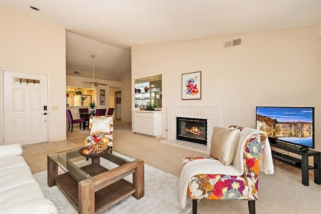 living room featuring ceiling fan, light colored carpet, and vaulted ceiling