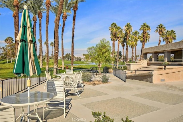 128 Desert Falls Dr E, Palm Desert, CA 92211 - view of patio featuring fence and a water view