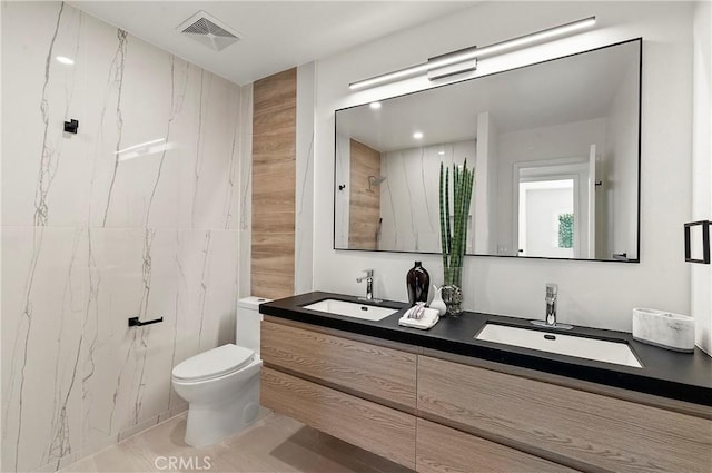 bathroom featuring vanity, toilet, and a shower