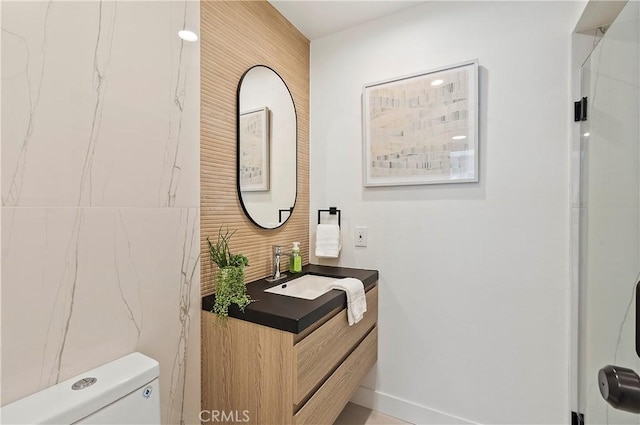 bathroom featuring vanity and toilet