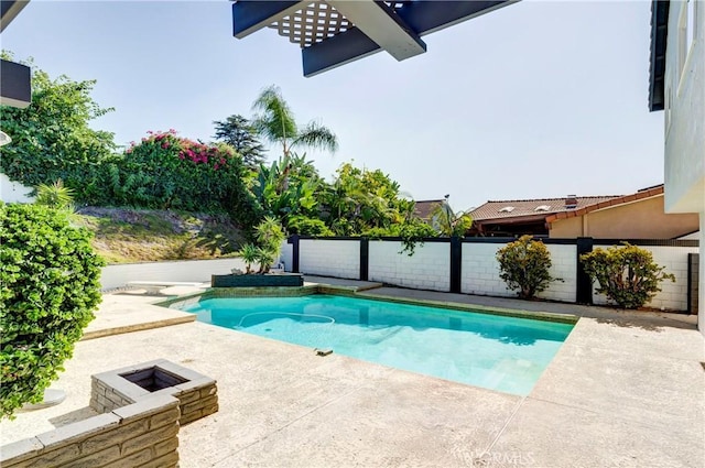 view of swimming pool featuring an outdoor fire pit and a patio area