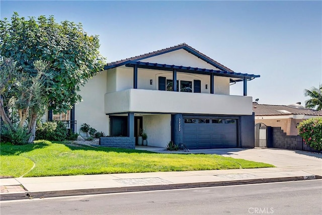 view of front of home with a garage, a balcony, and a front yard