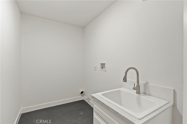 washroom with washer hookup, tile patterned floors, and sink