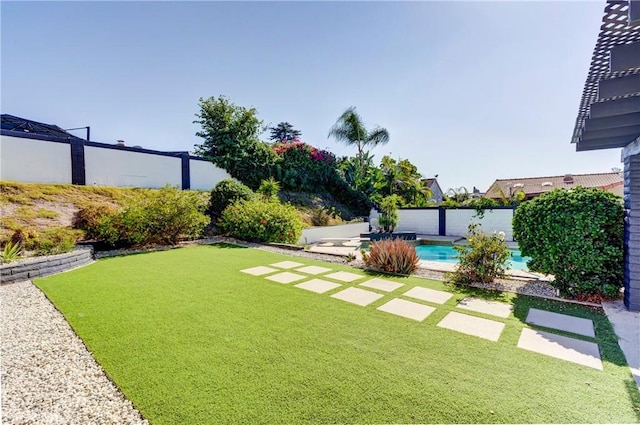 view of yard with a fenced in pool