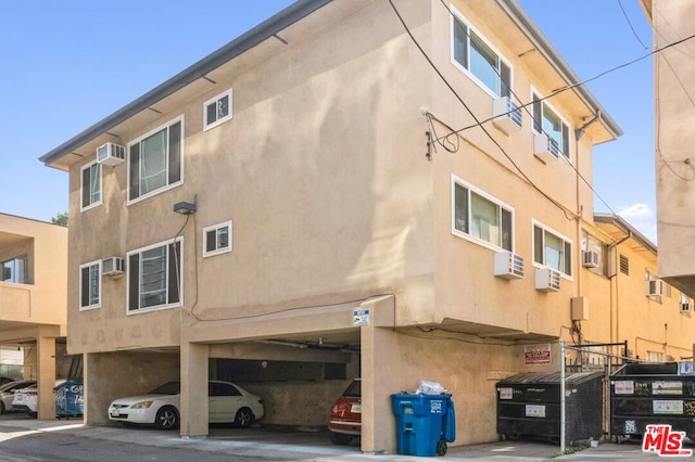 exterior space featuring an AC wall unit