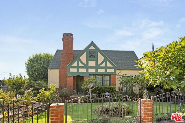 english style home with a front lawn