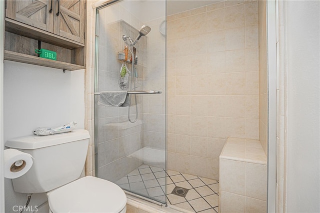 bathroom with a shower with shower door and toilet