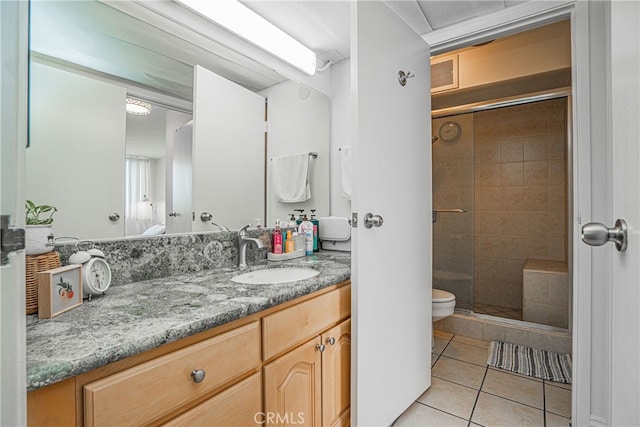 bathroom featuring walk in shower, tile patterned floors, vanity, and toilet