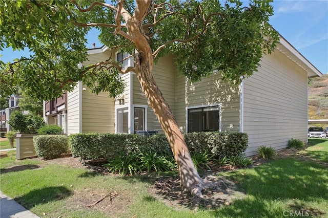 view of side of home featuring a lawn