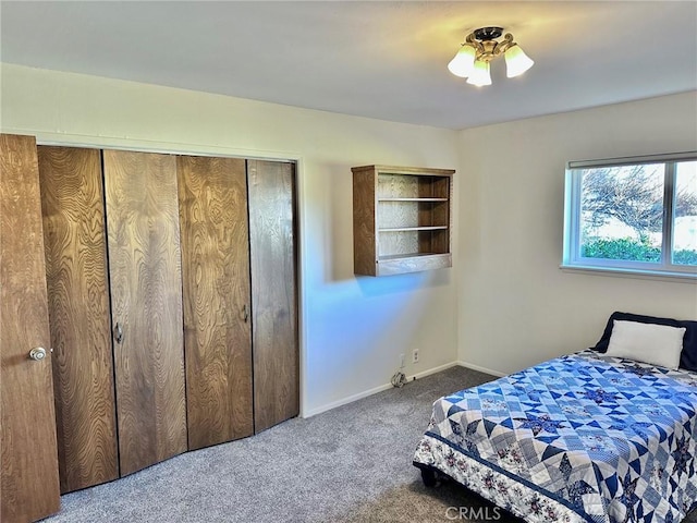 bedroom featuring ceiling fan, a closet, and carpet floors