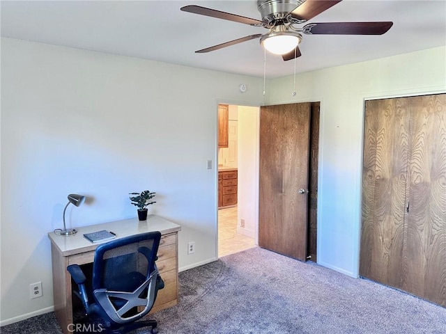 carpeted office space with ceiling fan