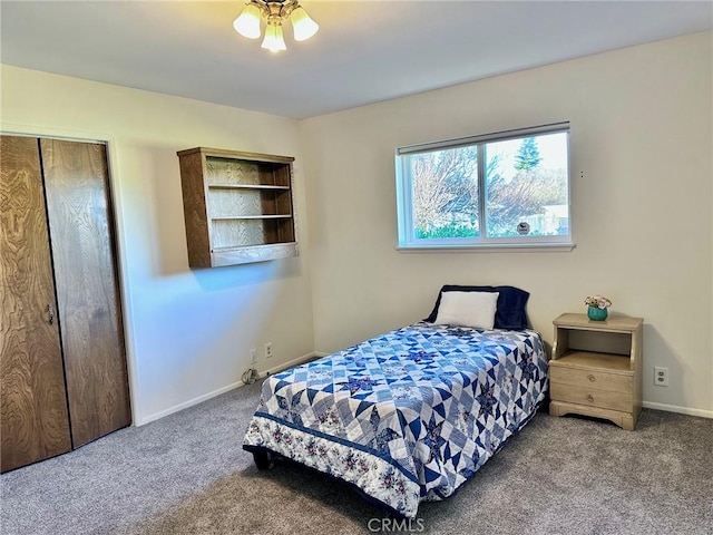 bedroom with ceiling fan, carpet, and a closet