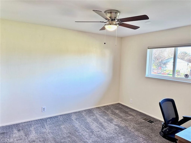 unfurnished office with ceiling fan and carpet flooring