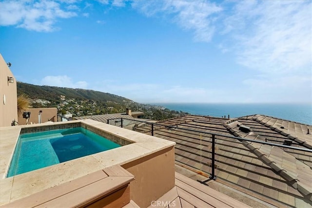 view of pool with a water view