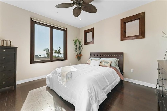 bedroom with ceiling fan and dark hardwood / wood-style flooring