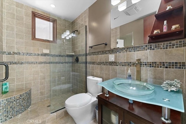 bathroom with toilet, tile walls, a shower with shower door, and vanity